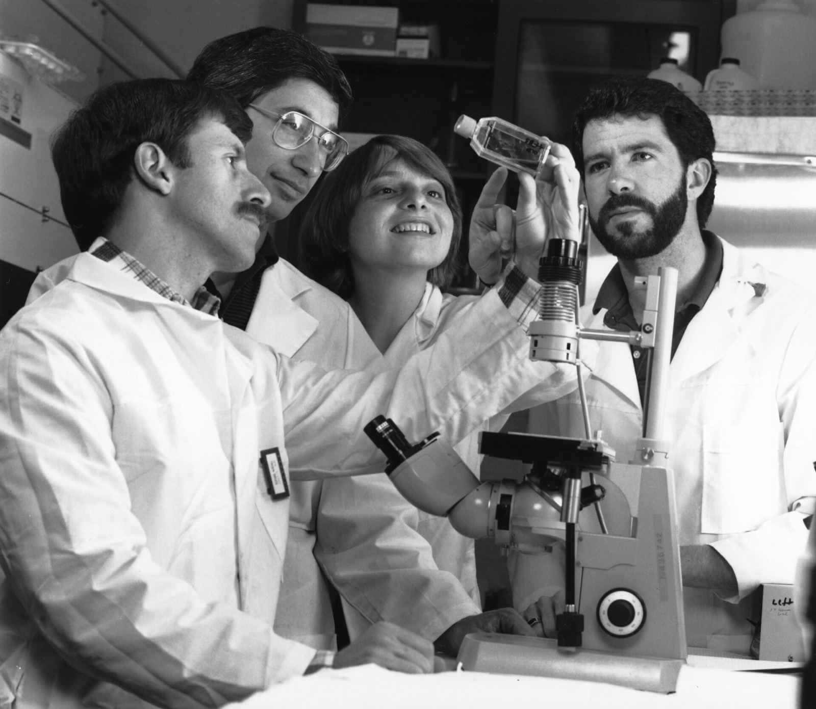 Scientists examining a culture flask in a laboratory